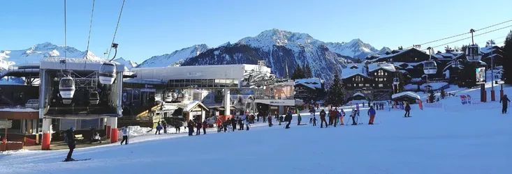 Skiers and ski lifts in an alpine resort